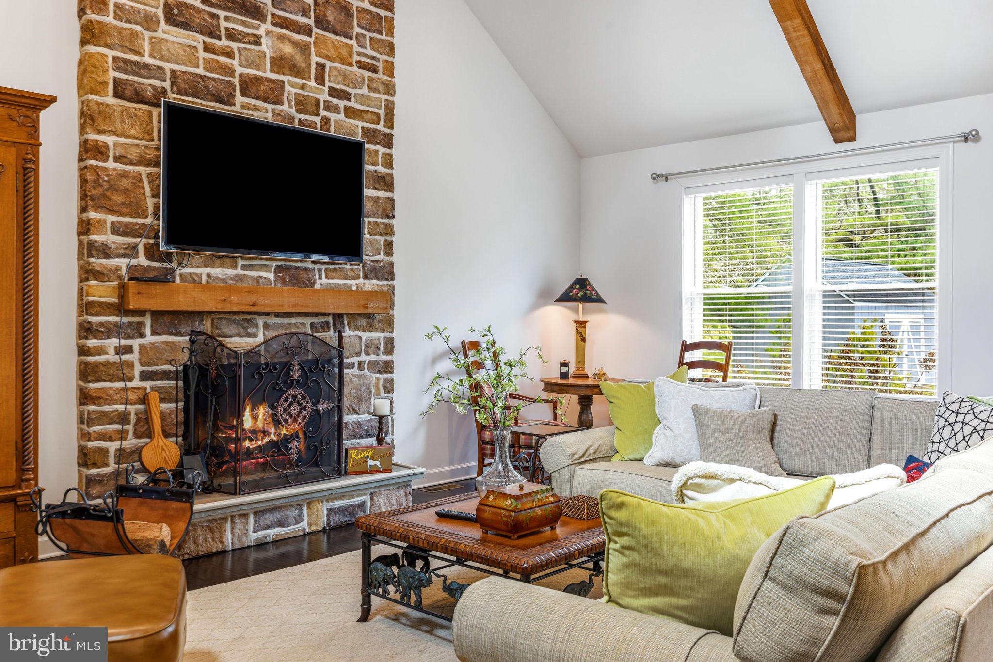 4126 Hedgehill Lane Phoenix, MD 21131 - Photo 12 of 54 a living room with furniture a flat screen tv and a fireplace