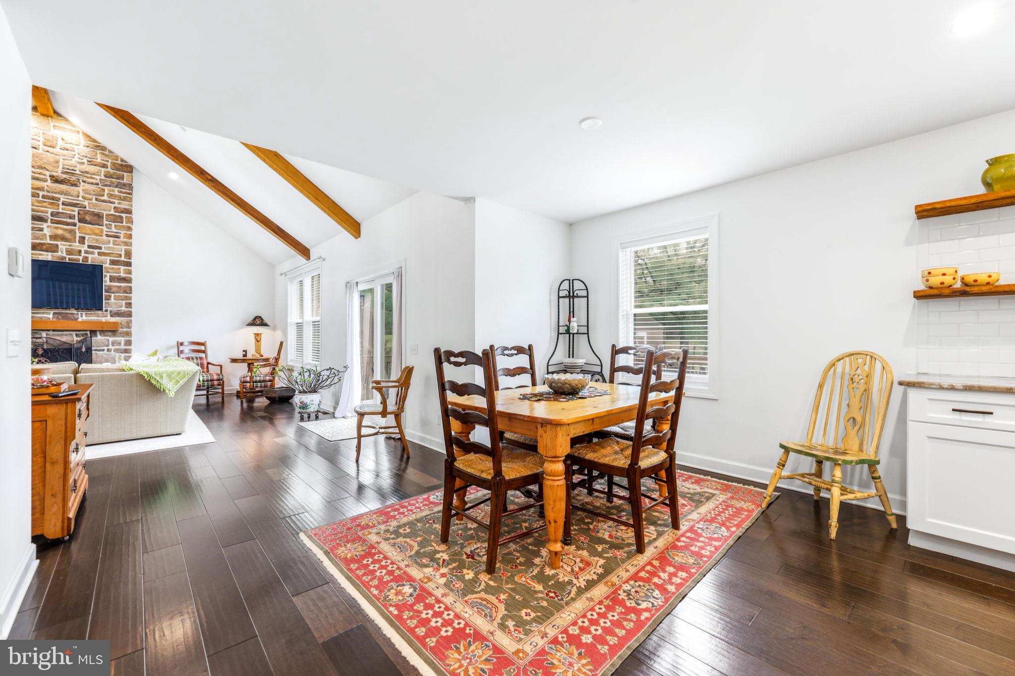 4126 Hedgehill Lane Phoenix, MD 21131 - Photo 18 of 54 a dining room with wooden floor a glass table and chairs