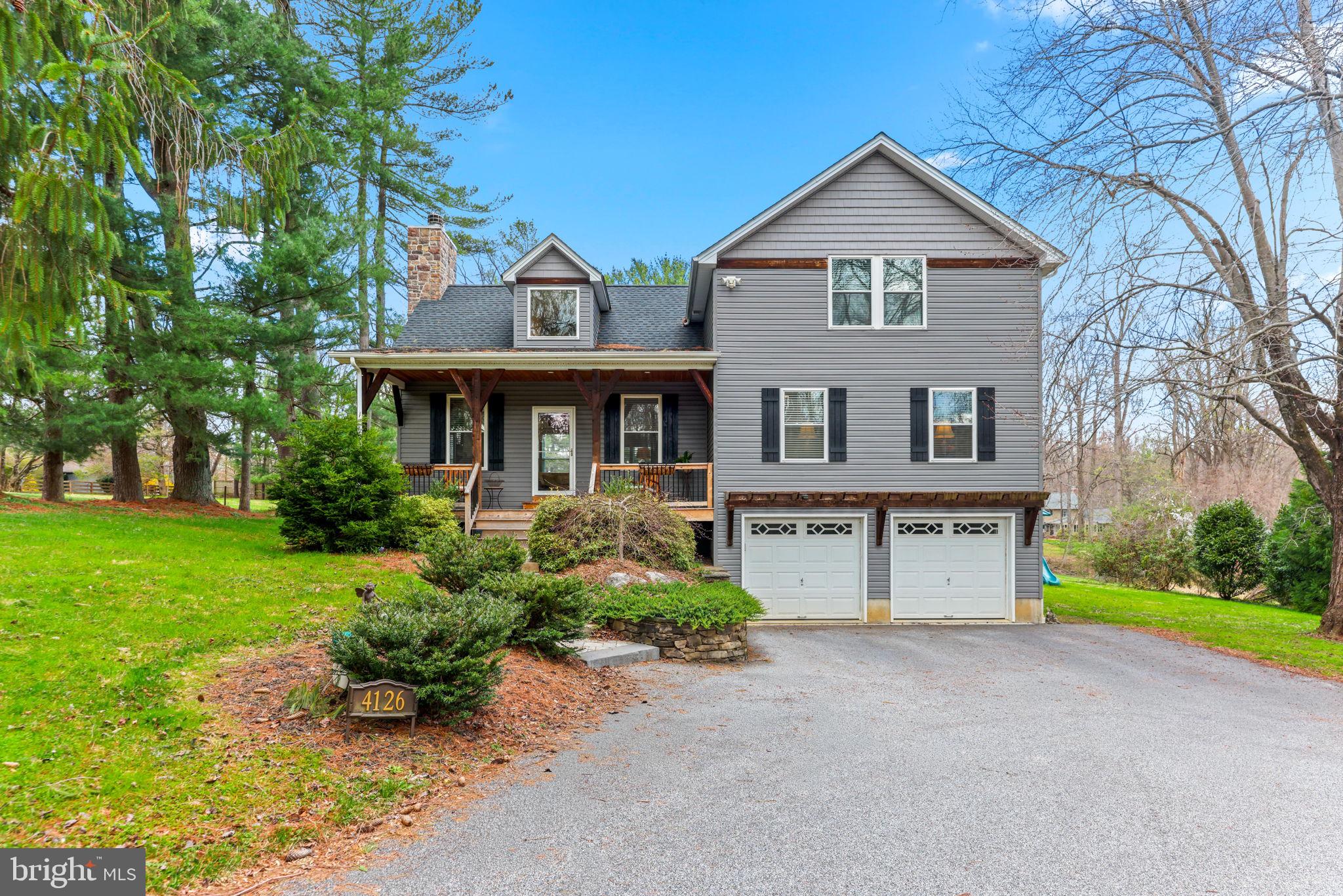 4126 Hedgehill Lane Phoenix, MD 21131 - Photo 2 of 54 a front view of a house with a yard and porch