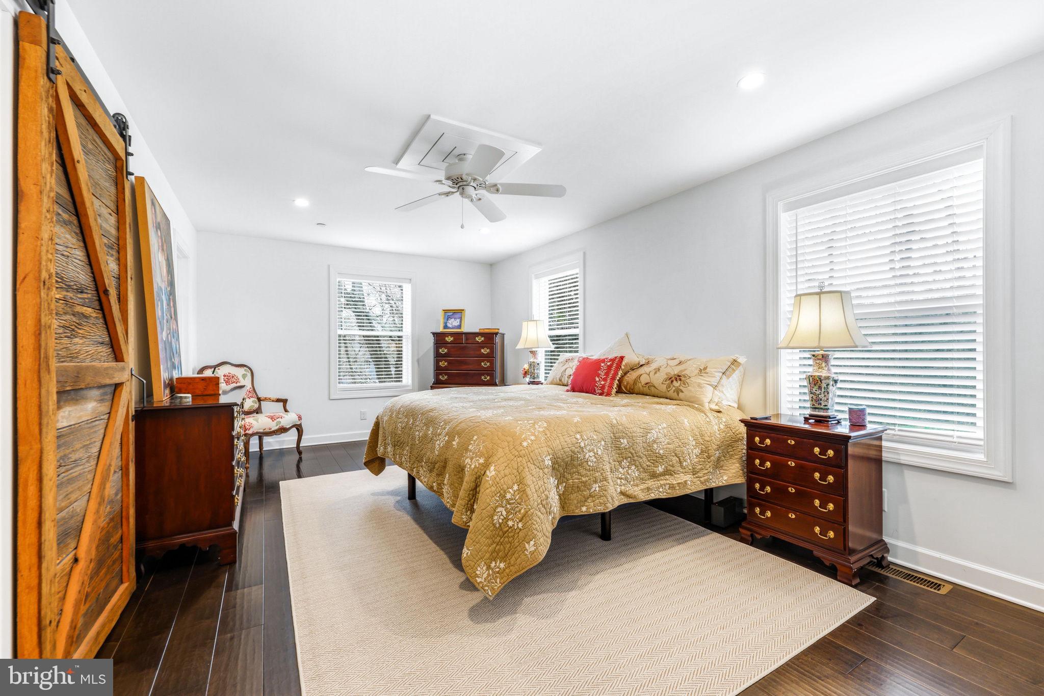4126 Hedgehill Lane Phoenix, MD 21131 - Photo 27 of 54 a spacious bedroom with a bed and wooden floor