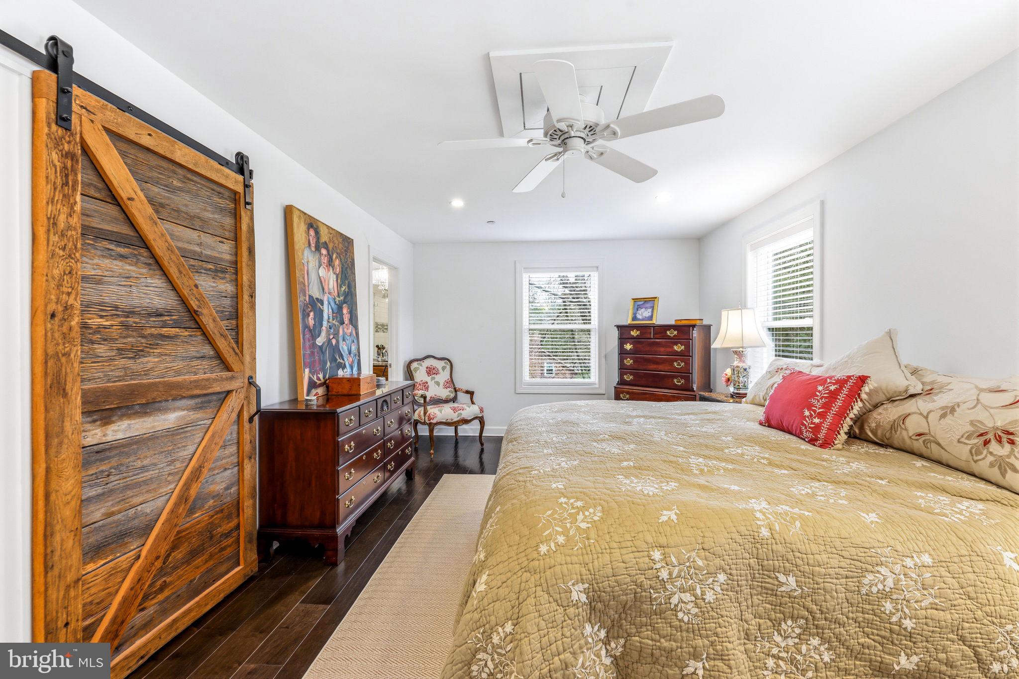 4126 Hedgehill Lane Phoenix, MD 21131 - Photo 28 of 54 a bedroom with a large bed and a chandelier