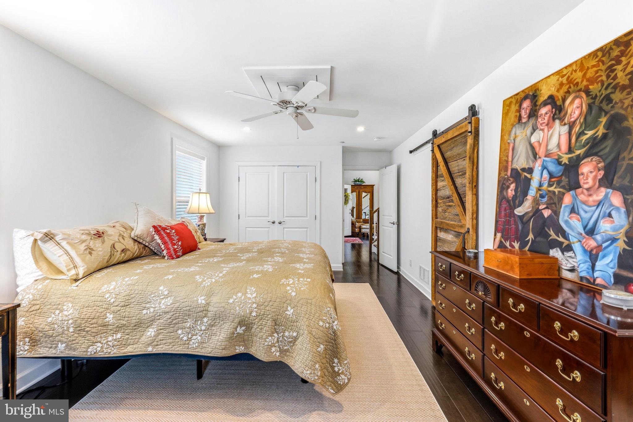 4126 Hedgehill Lane Phoenix, MD 21131 - Photo 29 of 54 a bedroom with a large bed and a chandelier