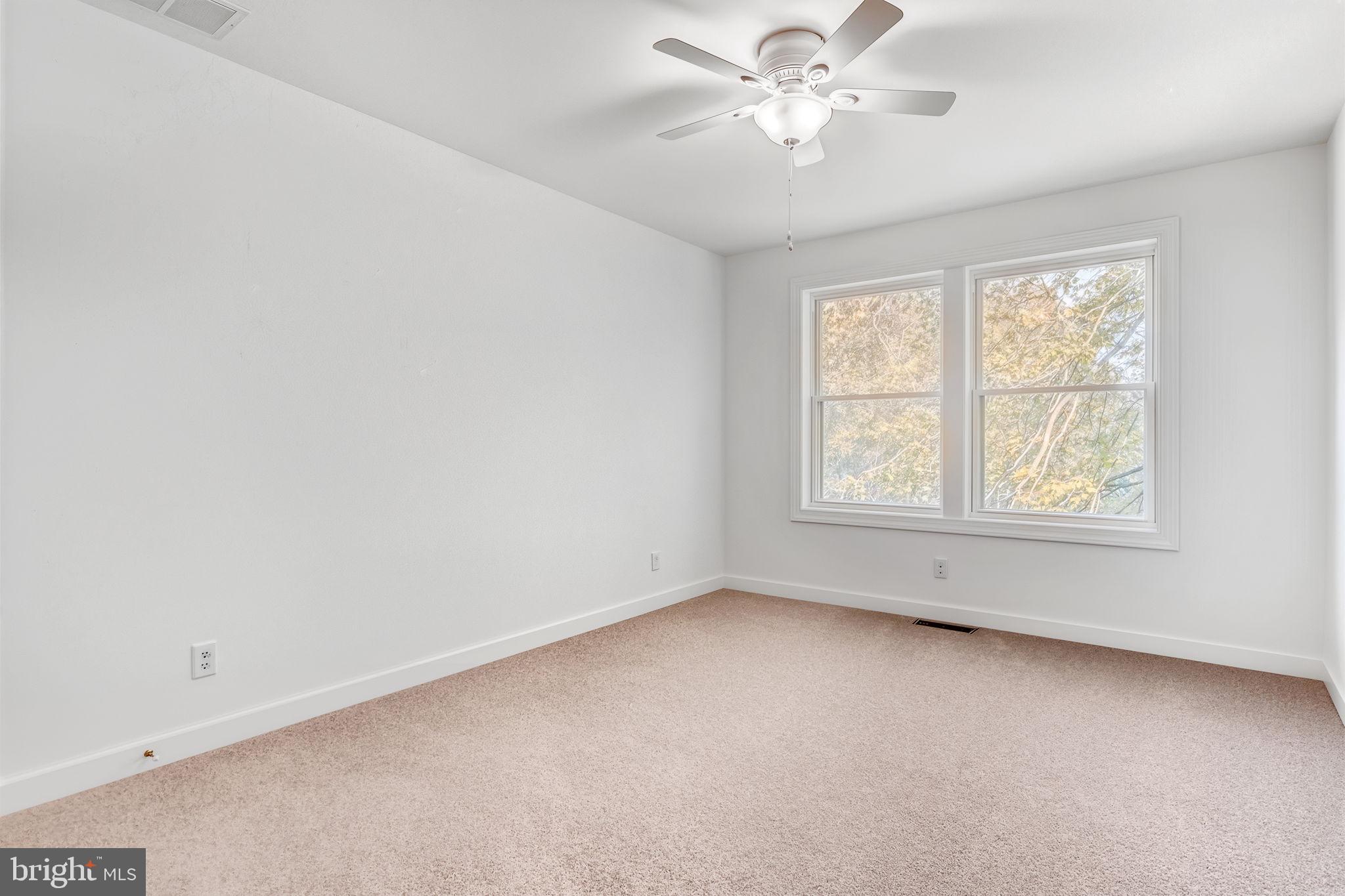 4126 Hedgehill Lane Phoenix, MD 21131 - Photo 39 of 54 an empty room with a window and a fan