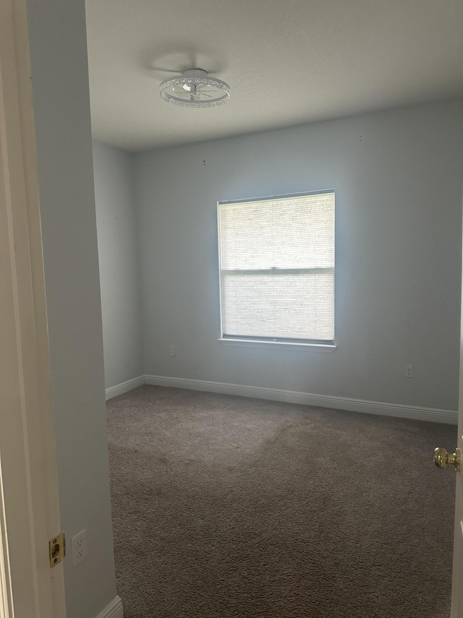 1218 Southwest Parma Avenue Port St. Lucie, FL 34953 - Photo 11 of 11 an empty room with a window