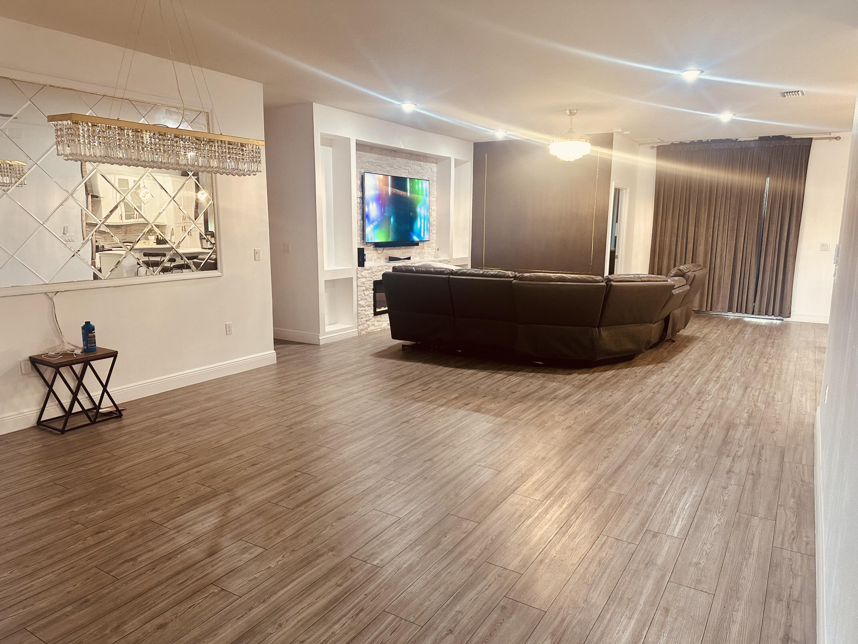 1218 Southwest Parma Avenue Port St. Lucie, FL 34953 - Photo 3 of 11 a living room with furniture and a wooden floor