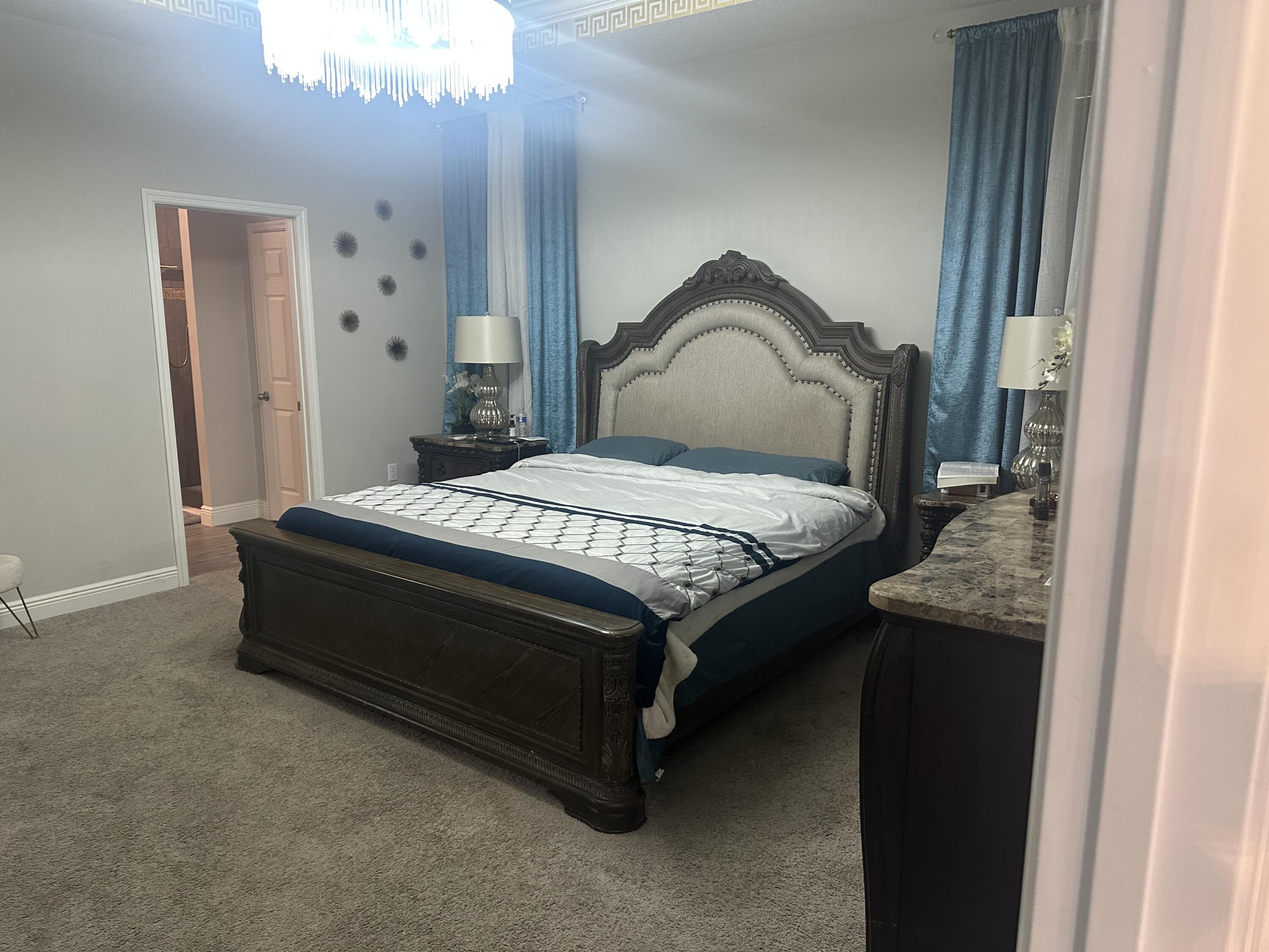 1218 Southwest Parma Avenue Port St. Lucie, FL 34953 - Photo 6 of 11 a bedroom with a bed and lamp