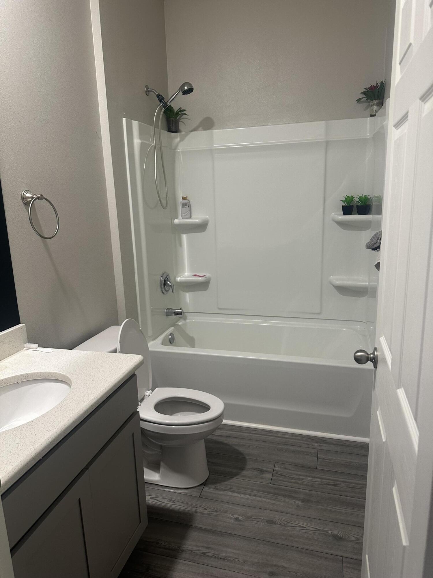 1218 Southwest Parma Avenue Port St. Lucie, FL 34953 - Photo 10 of 11 a bathroom with a sink a toilet and shower