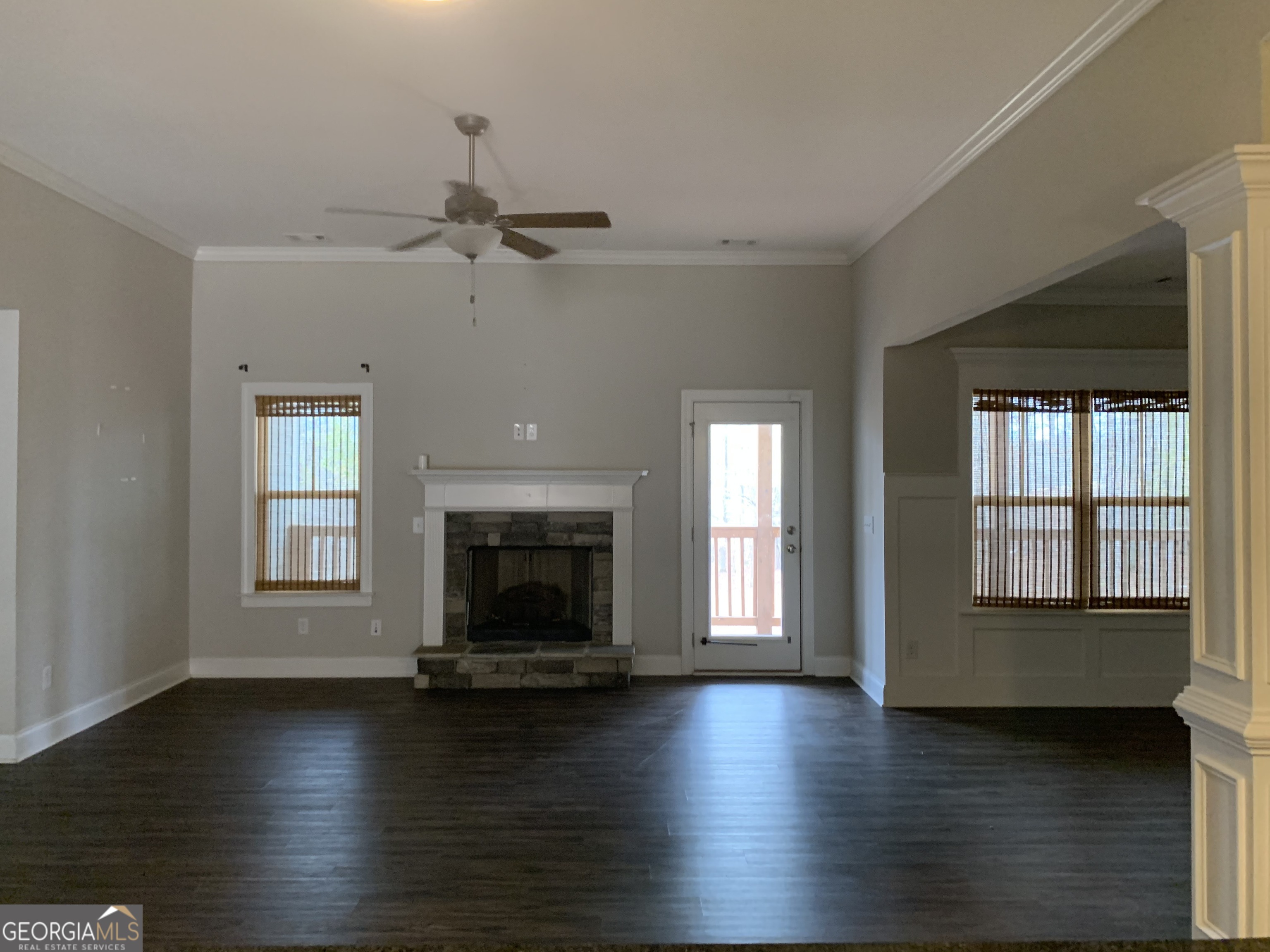30 Hollyhock Lane Covington, GA 30014 - Photo 3 of 8 an empty room with fireplace wooden floor and windows