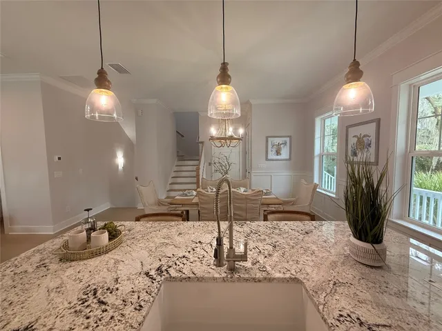 a living room with furniture and large windows