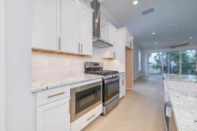 a kitchen with kitchen island a sink stainless steel appliances and window