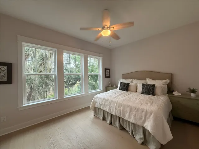 a large bedroom with a large bed and a large window