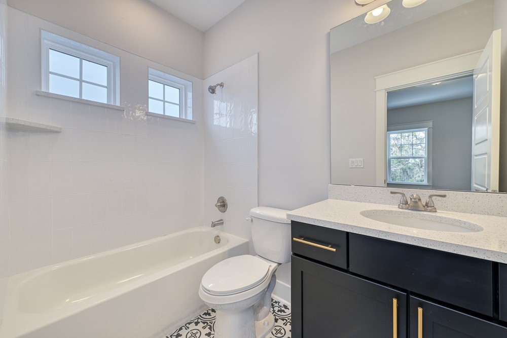 96561 Bay View Drive Fernandina Beach, FL 32034 - Photo 23 of 36 a bathroom with a sink toilet vanity and bathtub