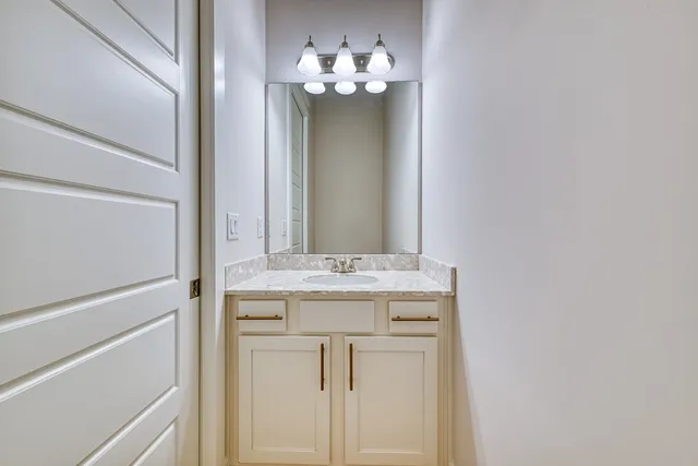 a large kitchen with kitchen island granite countertop a large window and stainless steel appliances