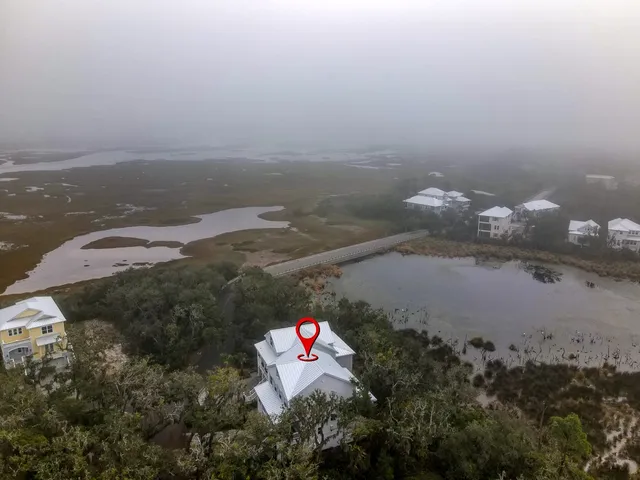 an aerial view of a house with a yard