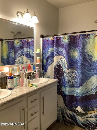 a bathroom with a granite countertop toilet a sink and a bathtub