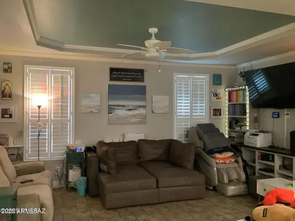 a living room with furniture a flat screen tv and a window