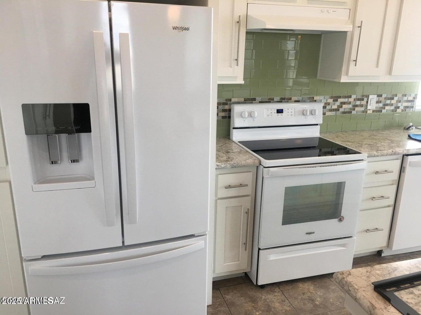 3736 Jackson Lane Willcox, AZ 85643 - Photo 7 of 36 a kitchen with white cabinets and white appliances