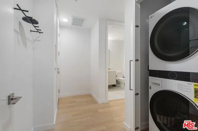 a view of a hallway with washer and dryer