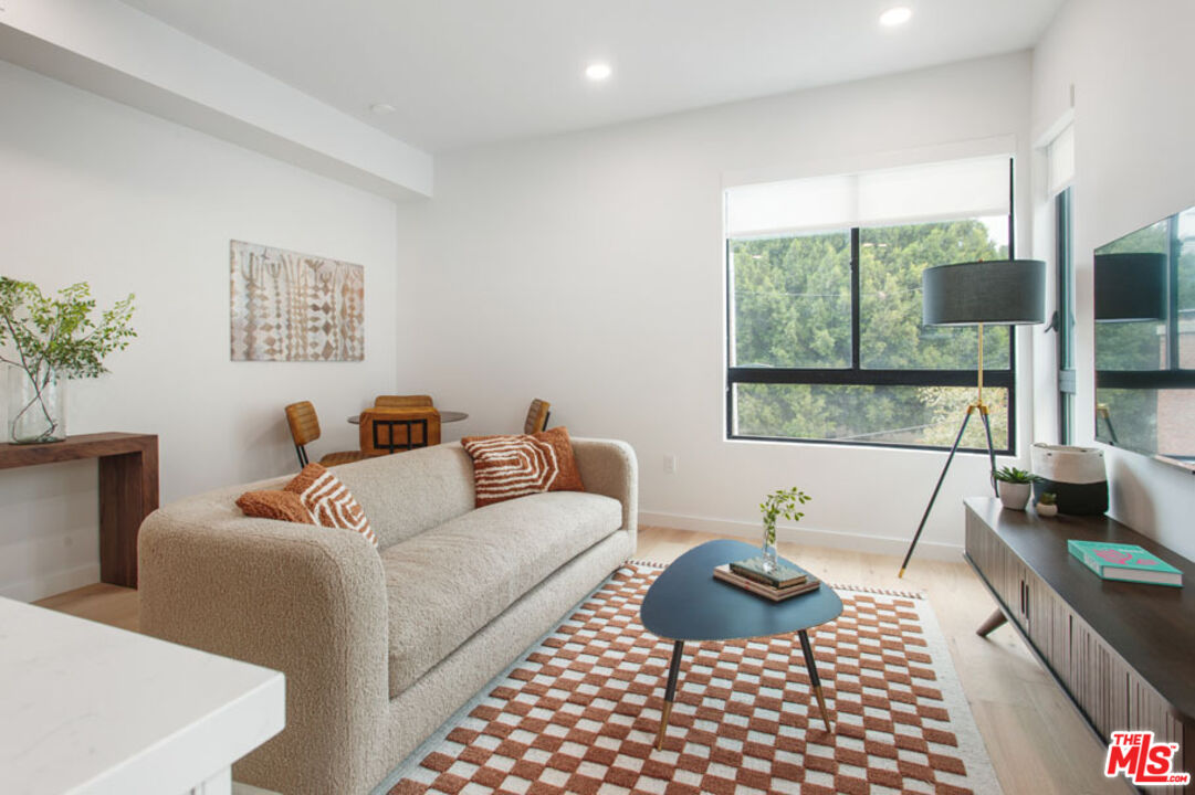 10310 Santa Monica Boulevard, Unit 612 Los Angeles, CA 90025 - Photo 4 of 37 a living room with furniture and a window