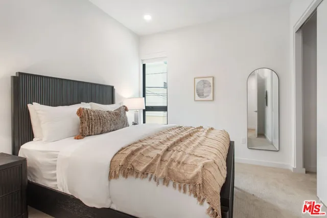 a bedroom with bed and window