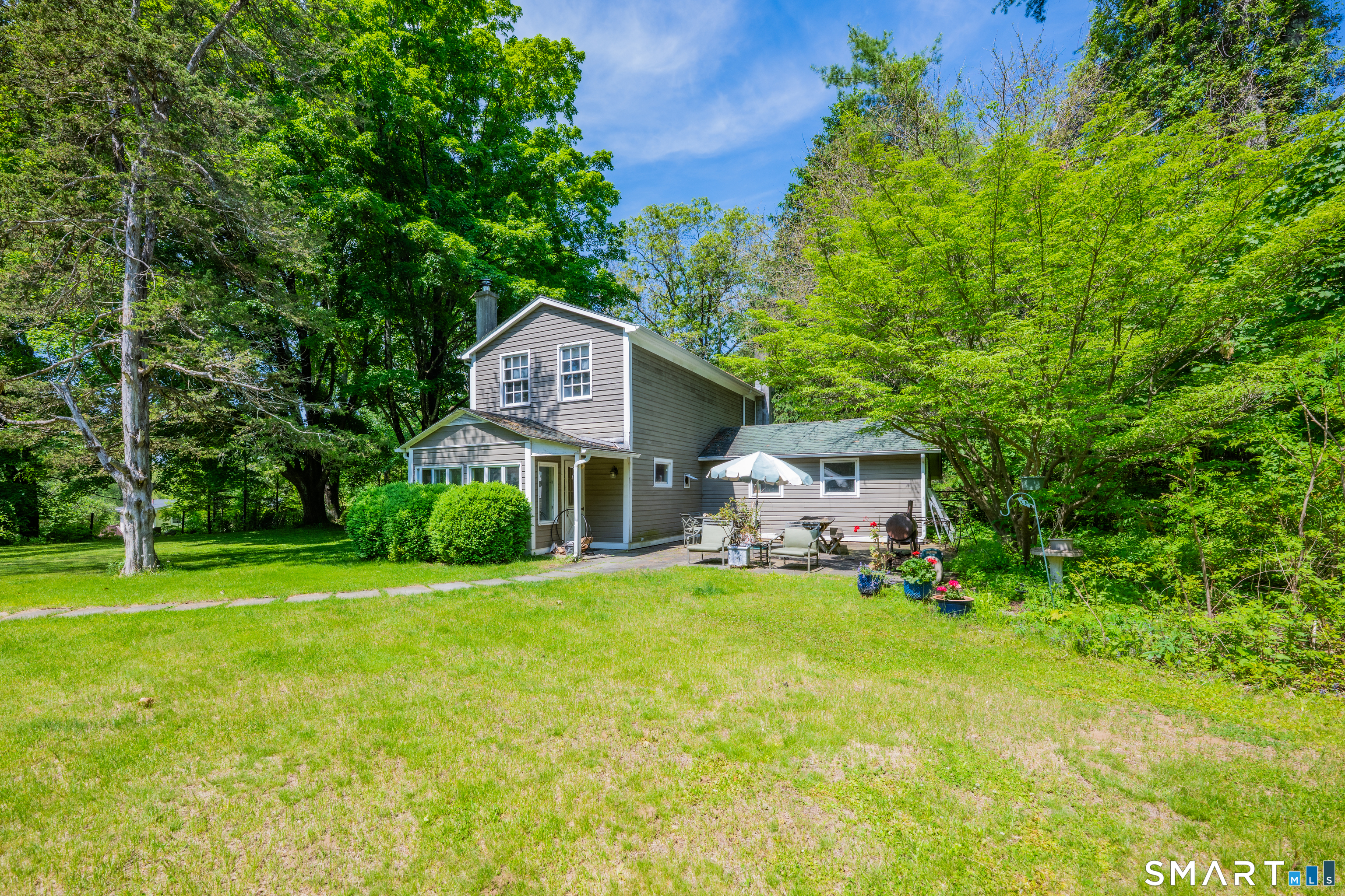 231 B Kent Road Kent, CT 06757 - Photo 2 of 35 a front view of a house with a yard and trees