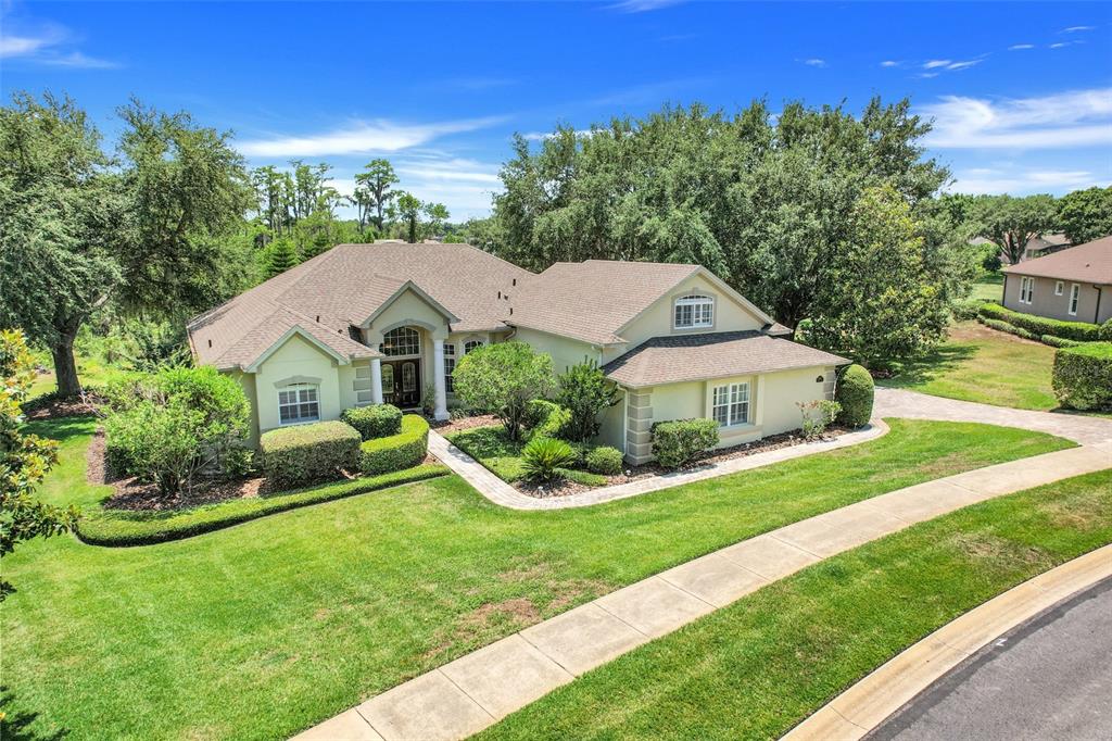 a aerial view of a house with a yard table and chairs