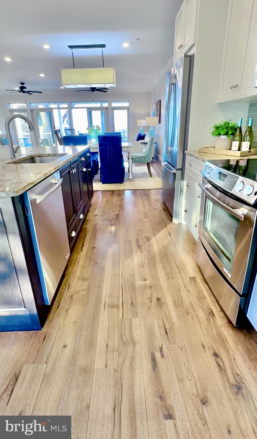 1538 Robinson Road Shady Side, MD 20764 - Photo 16 of 71 a kitchen with stainless steel appliances wooden floor dining table and chairs