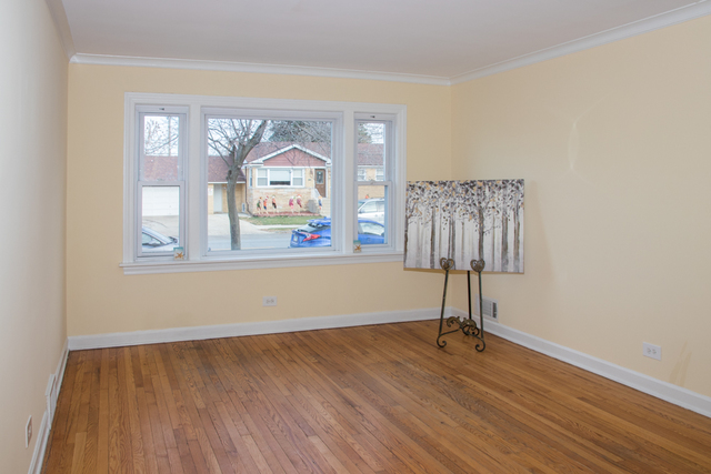 3943 West 83rd Street Chicago, IL 60652 - Photo 2 of 16 a view of a livingroom with wooden floor and a ceiling fan