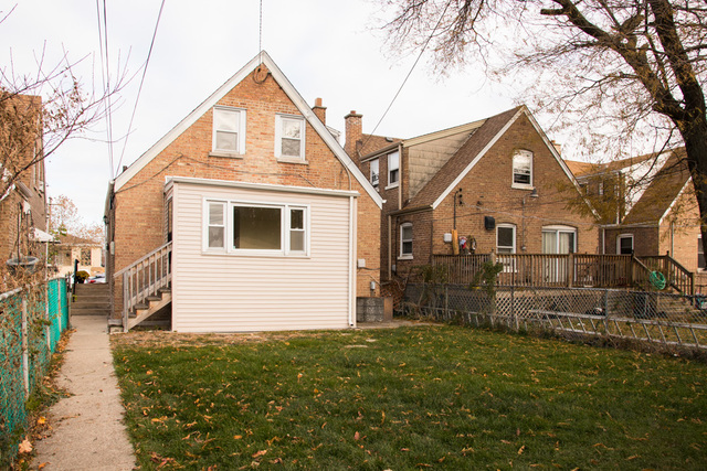 3943 West 83rd Street Chicago, IL 60652 - Photo 15 of 16 a front view of a house with a yard
