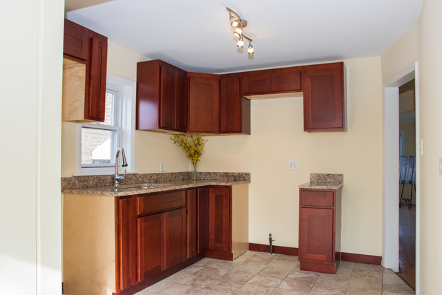 3943 West 83rd Street Chicago, IL 60652 - Photo 3 of 16 a kitchen with stainless steel appliances granite countertop a sink stove and cabinets