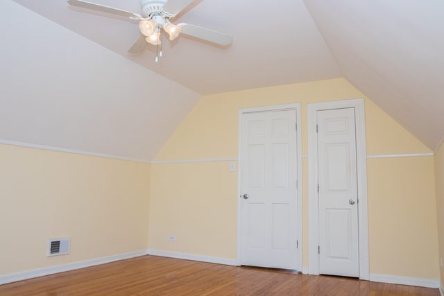 3943 West 83rd Street Chicago, IL 60652 - Photo 10 of 16 a view of an empty room with wooden floor