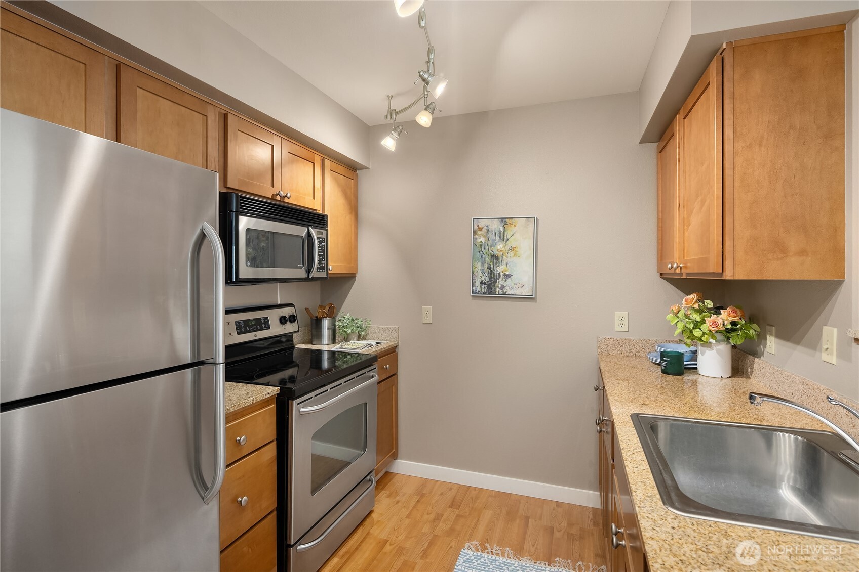300 High School Road Northeast, Unit 304 Bainbridge Island, WA 98110 - Photo 15 of 23 a kitchen with granite countertop a refrigerator stove and sink