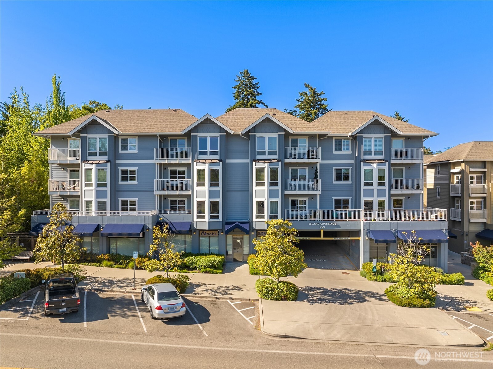 300 High School Road Northeast, Unit 304 Bainbridge Island, WA 98110 - Photo 2 of 23 a view of a patio with table and chairs potted plants