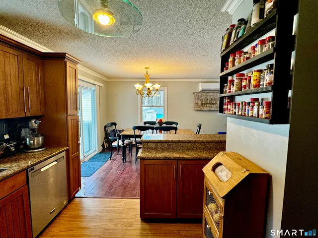 a kitchen with stainless steel appliances granite countertop a stove and a refrigerator