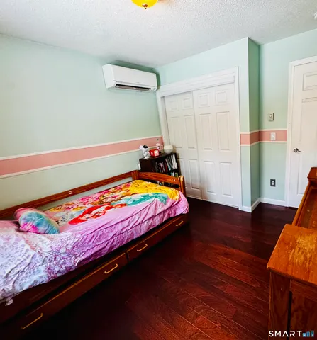 a bed sitting in a bedroom next to a window