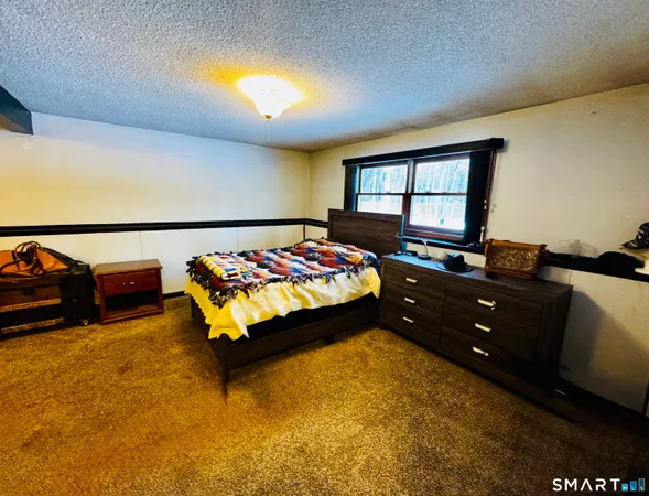 a bedroom with a bed and window