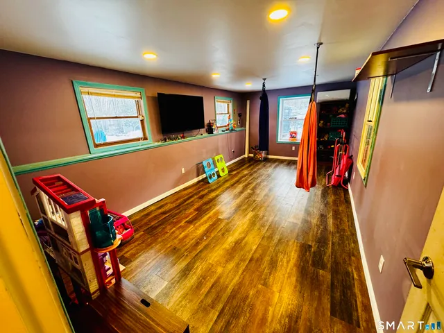 a view of an empty room with wooden floor
