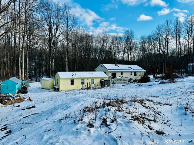 a view of a chair and tables in the patio
