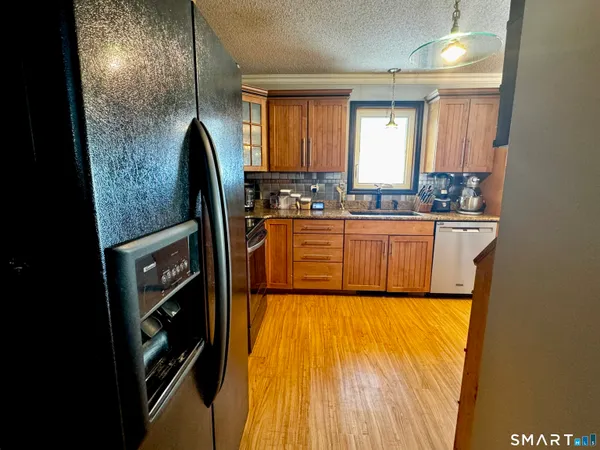 a view of a kitchen with a sink and wooden floor