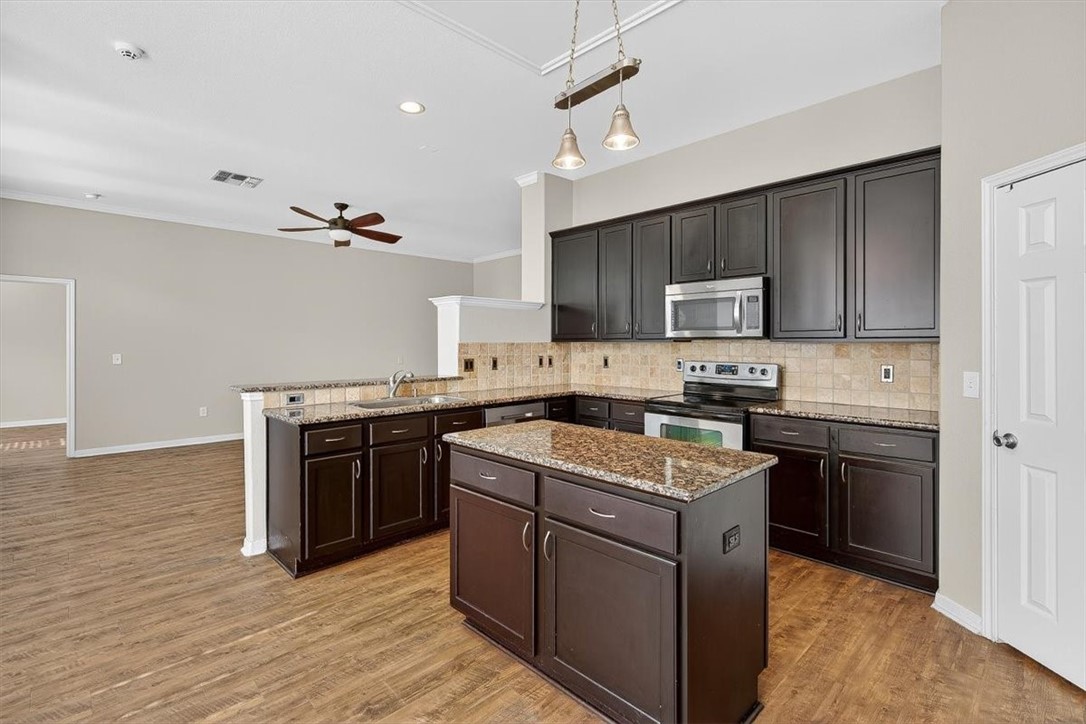 7506 Exeter Corpus Christi, TX 78414 - Photo 11 of 40 a kitchen with a stove sink and cabinets
