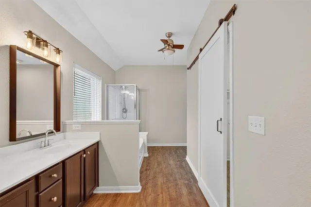 a bathroom with a sink a mirror and a shower
