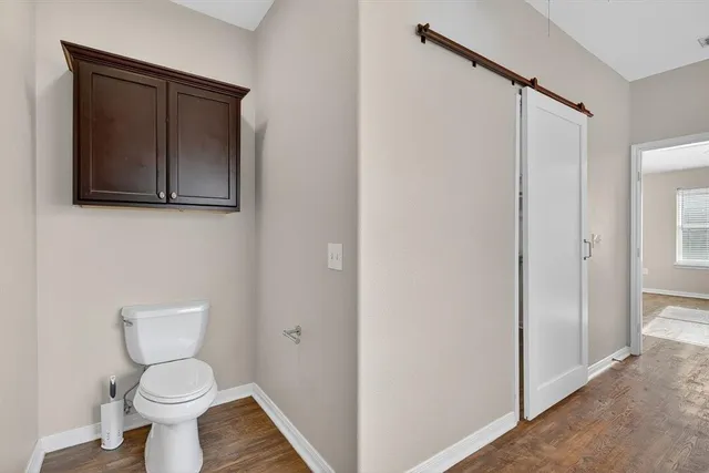 a white toilet sitting next to a bathroom sink