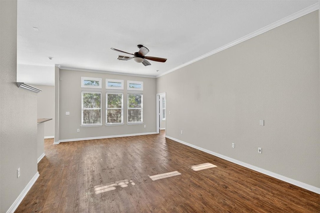 7506 Exeter Corpus Christi, TX 78414 - Photo 4 of 40 a view of an empty room with wooden floor and a window
