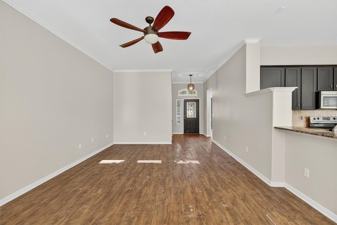 7506 Exeter Corpus Christi, TX 78414 - Photo 6 of 40 a view of a kitchen with a wooden floor and a ceiling fan