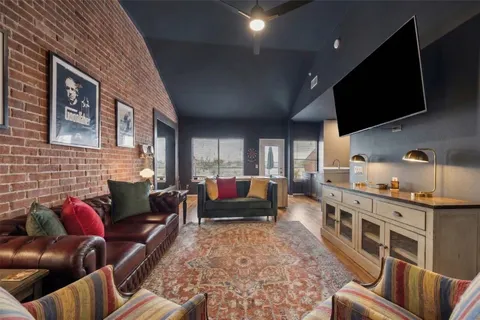 a living room with furniture fireplace and flat screen tv