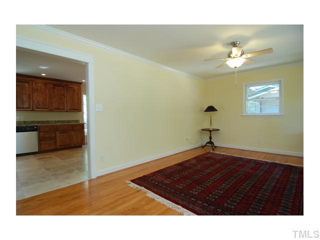 516 Princeton Street Raleigh, NC 27609 - Photo 10 of 23 a big room with wooden floor and cabinet