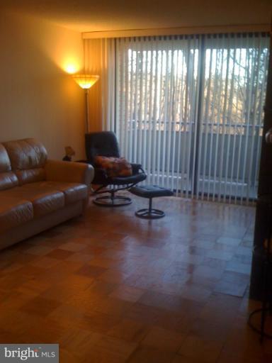 5225 Pooks Hill Road, Unit 406N Bethesda, MD 20814 - Photo 7 of 18 a living room with furniture and a large window