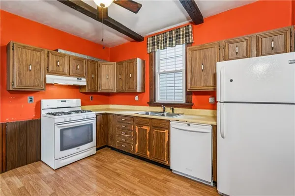 a kitchen with stainless steel appliances granite countertop a stove and a refrigerator