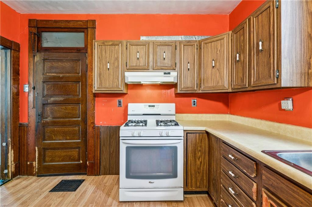 1369 5th Avenue Freedom, PA 15042 - Photo 22 of 41 a kitchen with stainless steel appliances granite countertop a stove and a refrigerator