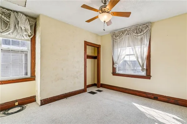 an empty room with windows and entrance